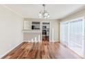 Dining room with hardwood floors, slider to back yard, and open to the kitchen at 3670 Leisure Ln, Atlanta, GA 30349