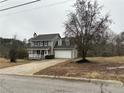 Gray two-story house with a white garage door and a tree in front at 43 Oak Landing Dr, Douglasville, GA 30134