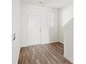 Simple entryway with wood-look floors and interior door at 1646 Larkspur Trl, Conyers, GA 30012