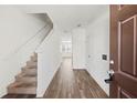 Inviting entryway with stairs leading upstairs and wood-look floors at 1646 Larkspur Trl, Conyers, GA 30012