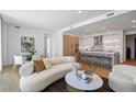 Open-concept living area with kitchen, dining space, sleek furniture, and a large painting for decor at 2425 Peachtree Rd # 508, Atlanta, GA 30305