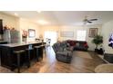 Open living area with sectional sofa and wood floors at 7229 Deering Ct, Douglasville, GA 30134