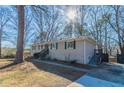 Updated ranch home exterior with attractive landscaping and a large yard at 3887 Mcgill Ln, Decatur, GA 30034