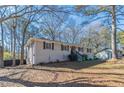 Side view of charming ranch home with newly painted exterior and well-manicured lawn at 3887 Mcgill Ln, Decatur, GA 30034