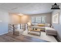 Bright staged living room featuring modern furniture, neutral color palette, and natural light from a window at 5938 Baywood Ln, Riverdale, GA 30296