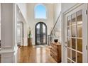 Bright and airy entryway with hardwood floors and an arched window at 3134 Denton Ne Pl, Roswell, GA 30075