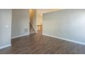 Open dining area with hardwood floors and staircase at 2105 Sandtree Sw Ct, Atlanta, GA 30331