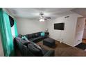 Bright living room with sectional sofa, flat-screen TV, and ceiling fan at 4701 Flat Shoals Rd # 48G, Union City, GA 30291