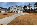 Gray two-story house with a long driveway and a spacious yard at 1441 Stephens View Dr, Loganville, GA 30052