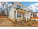 Charming two-story home with a brick and siding facade, a covered porch, and a well-manicured front yard at 261 Martin Spring Rd, Lawrenceville, GA 30045