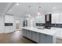 Modern kitchen with white cabinets, quartz countertops, and stainless steel appliances at 883 Gaston Sw St, Atlanta, GA 30310