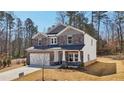 Beautiful two-story home showcasing a two-car garage and a stone and siding exterior on a large lot at 281 Martin Spring Rd, Lawrenceville, GA 30045
