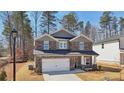 Attractive two-story home featuring stone accents, a spacious two-car garage and manicured front yard at 281 Martin Spring Rd, Lawrenceville, GA 30045