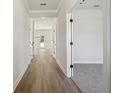 Bright hallway with hardwood floors leading to carpeted bedrooms and an open-concept living area at 281 Martin Spring Rd, Lawrenceville, GA 30045