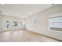 Bright living room featuring wood floors, recessed lighting and ample windows offering plenty of natural light at 711 Lily Blossom Path, Lawrenceville, GA 30045
