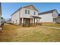 Inviting two-story house featuring stone detailing, a covered porch, and a concrete sidewalk at 1260 Firefly Field Trce Trce, Lawrenceville, GA 30045