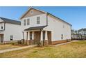 Attractive two-story house featuring stone detailing, a covered porch, and a concrete sidewalk at 1260 Firefly Field Trce Trce, Lawrenceville, GA 30045