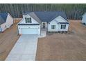 House with driveway and a yard, in a wooded area at 180 Eryn Ter, Covington, GA 30014