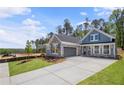 Charming two story home with craftsman elevation, lush lawn, and gray two car garage at 48 Easton Park Blvd, Dallas, GA 30157