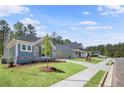 Street view of craftsman homes with well-manicured lawns and sidewalks at 48 Easton Park Blvd, Dallas, GA 30157