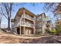 Rear view of the condo building showcasing multiple units and wooded area at 906 Country Park Se Dr, Smyrna, GA 30080