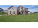 Two-story home with brick and siding exterior, landscaped lawn, and driveway at 205 Blanton Ln, Stockbridge, GA 30281