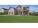 Two-story home with brick and siding exterior, landscaped lawn, and driveway at 205 Blanton Ln, Stockbridge, GA 30281