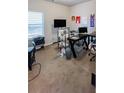 Bright home office with neutral carpeting, featuring a large desk and window at 231 Magnaview Dr, Mcdonough, GA 30253