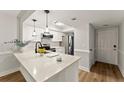 Modern kitchen with white cabinets, quartz countertops and stainless steel appliances at 1101 New Horizon St, Powder Springs, GA 30127