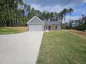 Newly built home with gray siding, two-car garage and landscaped lawn at 420 Florence Rd, Douglasville, GA 30134