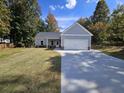 Newly built home with gray siding, two-car garage and landscaped lawn at 420 Florence Rd, Douglasville, GA 30134