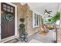 Inviting front porch with rocking chairs and decorative lanterns at 3051 Oglethorpe Ne Way, Brookhaven, GA 30319