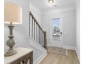 Bright entryway with hardwood floors, a staircase, and a table with a lamp at 2133 Kirkham Way, Kennesaw, GA 30152
