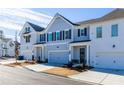 Row of townhomes with gray and white siding, two-car garages, and a paved street at 2133 Kirkham Way, Kennesaw, GA 30152