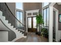 Elegant foyer with curved staircase, hardwood floors, and abundant natural light at 331 Wages Rd, Auburn, GA 30011