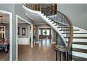 Elegant foyer with curved staircase, hardwood floors, and abundant natural light at 331 Wages Rd, Auburn, GA 30011