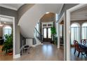 Elegant foyer with curved staircase, hardwood floors, and abundant natural light at 331 Wages Rd, Auburn, GA 30011