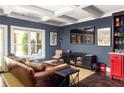 Finished basement with a bar, seating area, and a large TV at 9060 Selborne Ln, Chattahoochee Hills, GA 30268