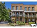 Brick townhome with multiple levels, balconies, and a charming street view at 9060 Selborne Ln, Chattahoochee Hills, GA 30268