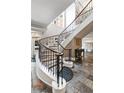 Sweeping staircase featuring dark ornate rails and large tile flooring in the entryway at 560 Dutch Valley Ne Rd # 209, Atlanta, GA 30324