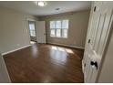 Cozy bedroom showcasing hardwood floors, large windows, and closet space at 1929 Hazelwood Se Dr, Marietta, GA 30067