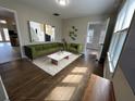 Inviting living room features stylish green seating, modern artwork, and gleaming hardwood floors at 1929 Hazelwood Se Dr, Marietta, GA 30067
