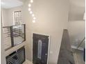 Inviting entryway featuring a modern chandelier and stylish front door at 4064 Chimney Ridge Way, Ellenwood, GA 30294