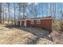 Side view of brick ranch house with yard at 7771 Mattie Mccoy Ln, Winston, GA 30187