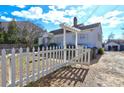 White house with a picket fence and pergola at 153 Hill St, Roswell, GA 30075