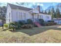 Front view of a charming white single story house with a yard at 153 Hill St, Roswell, GA 30075