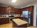 Island kitchen with stainless steel appliances and granite countertops at 730 Donner Ct, Mcdonough, GA 30252