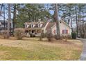 Two-story house with a wraparound porch and landscaped yard at 2020 Temple Johnson Rd, Loganville, GA 30052