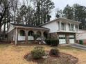 Two-story brick home with a double-car garage and mature trees at 2289 Aurie Dr, Decatur, GA 30034