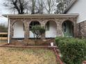 Brick front porch with arched entryway and green door at 2289 Aurie Dr, Decatur, GA 30034